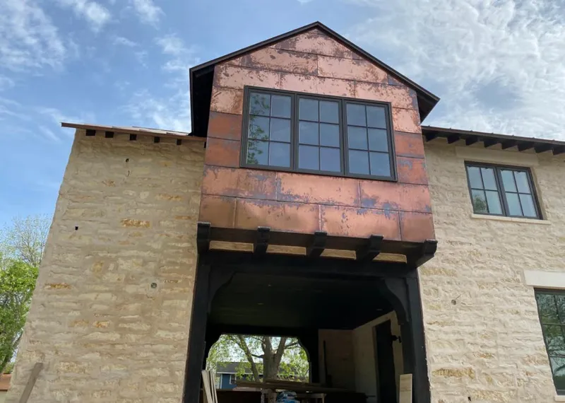 Copper metal panel facade on a stone building for Skylight Installation in Half Moon Bay